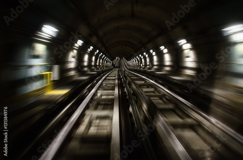 Metro subway of Turin (Italy), dark tunnel with rails and motion blur seen from the running train