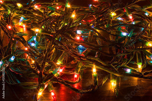 Tablou pe pânză Tangled Christmas lights on a table