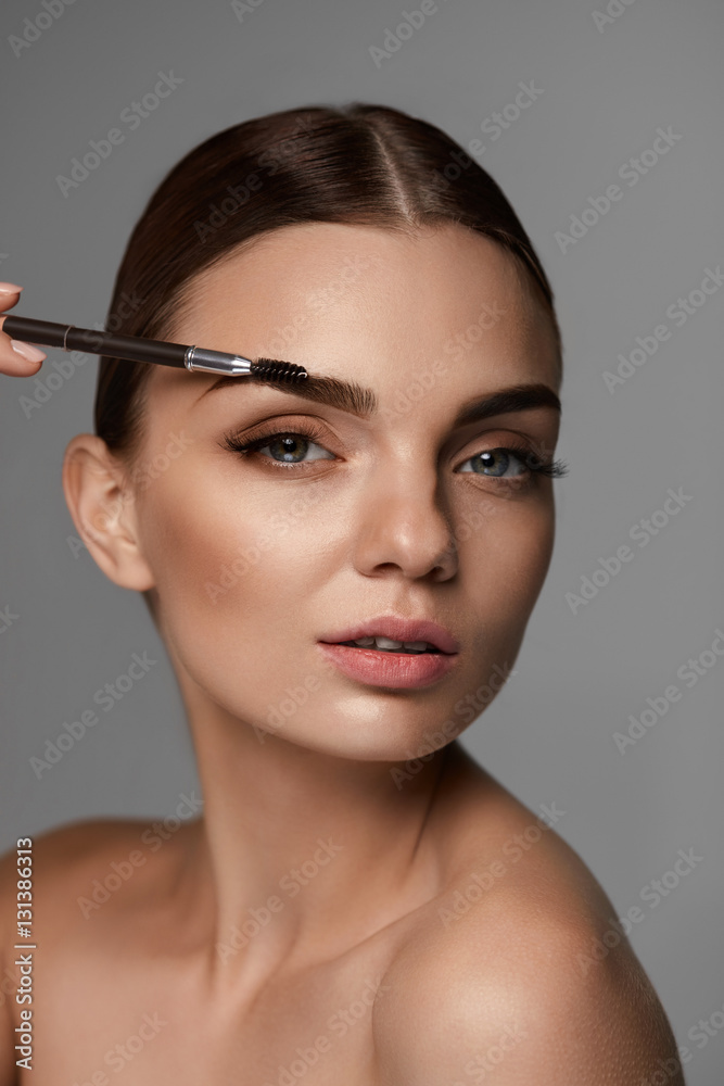 Beautiful Woman Brushing Eyebrows With Brow Tool