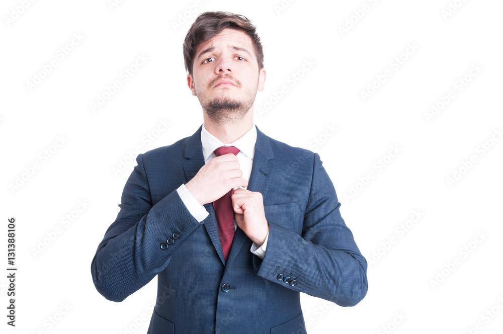 Elegant young man arranging tie wearing elegant suit Elegant young man arranging tie wearing elegant suit