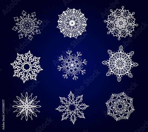 Set of vector snowflakes on the blue background