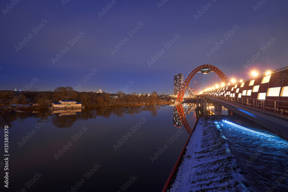 Light track. The photo a bridge with arch and pier. Moscow. Russia.