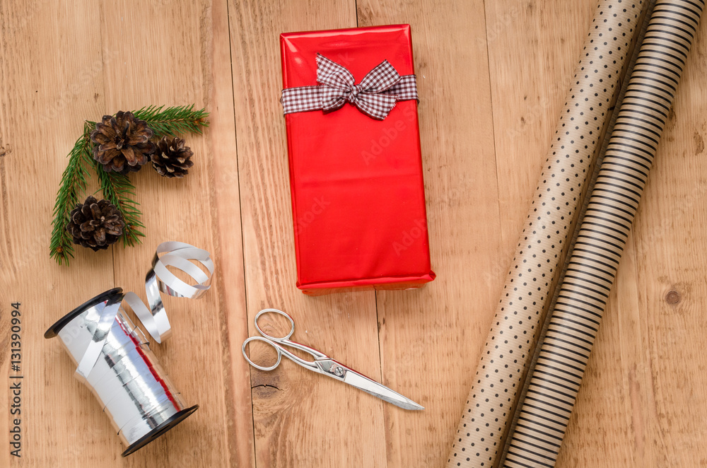 Christmas Gift Wrapping Composition with a Present, Rolls of Wrapping