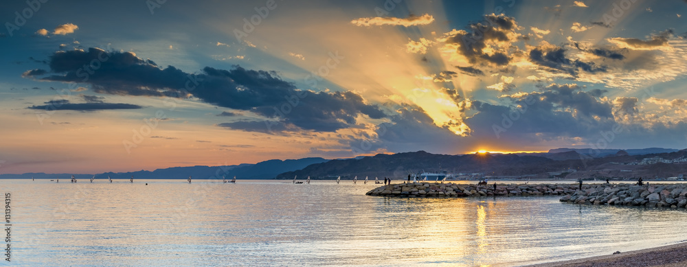 View on the Red Sea from a public beach of Eilat, Israel. The photo was taken during colorful sunset