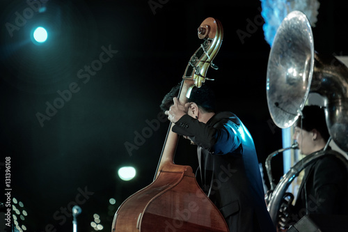 Photography Jazz / View of musician playing the contrabass in concert at night