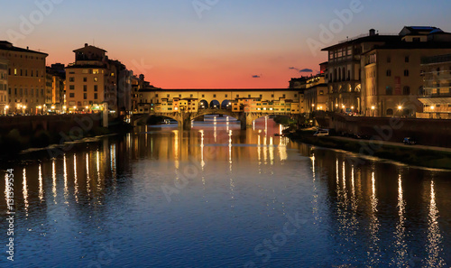 Ponte Vecchio - the oldest bridge of the city of Florence. River Arno, sunset, Tuscany, Italy, the reflection in the water. © Alexander