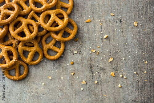 Salted pretzels on wooden background