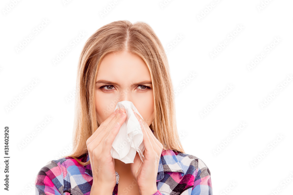Young sick woman having allergy and sneezing in tissue Young sick woman having allergy and sneezing in tissue