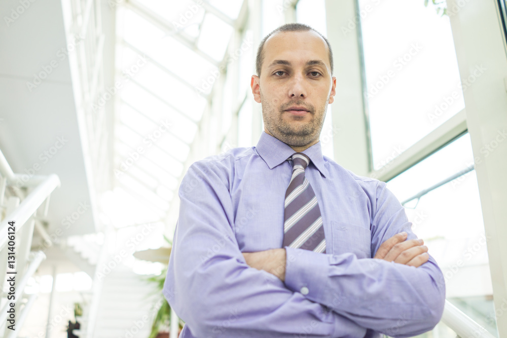 Young businessman in office building Young businessman in office building