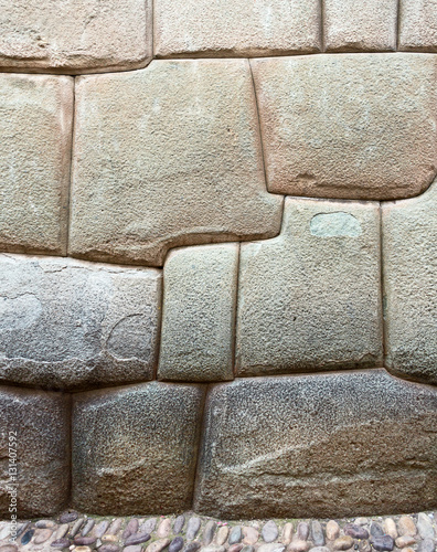 The multi-sided granite stones in ancient Inca wall street Hatunrumiyoc - Cusco, Peru photo