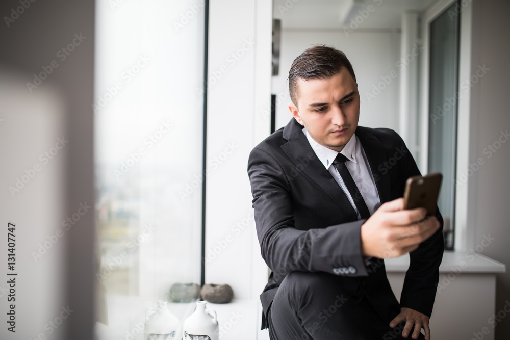 Successful manager using mobile phone in office Successful manager using mobile phone in office
