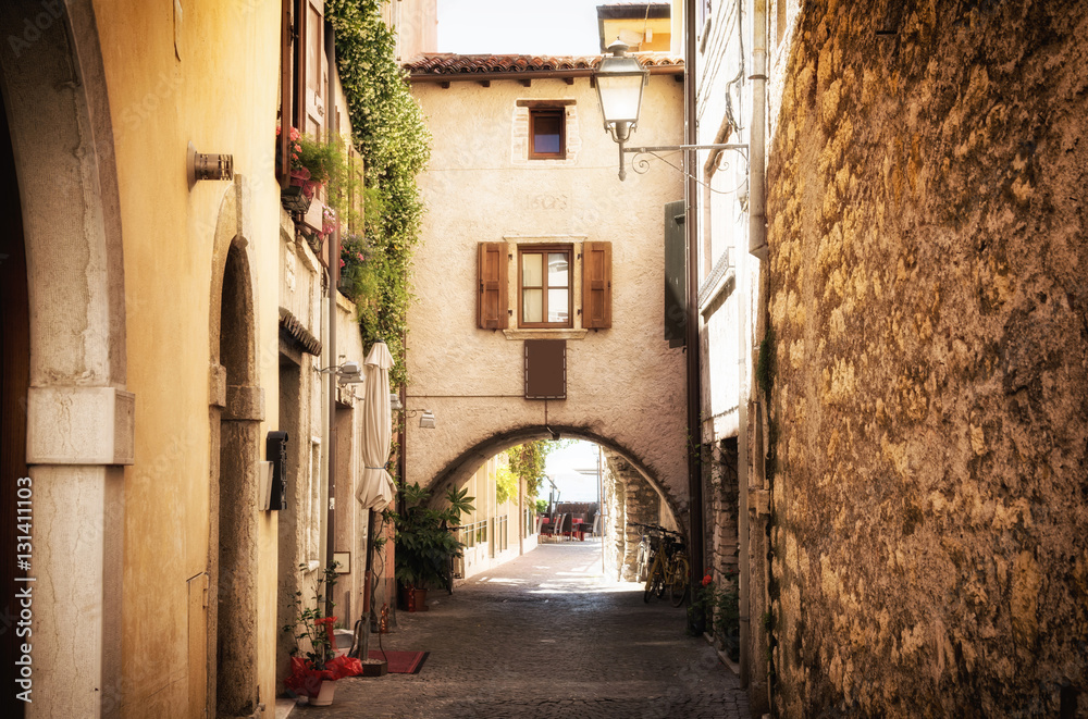 narrow street in medieval old town on Lake Garda in Italy