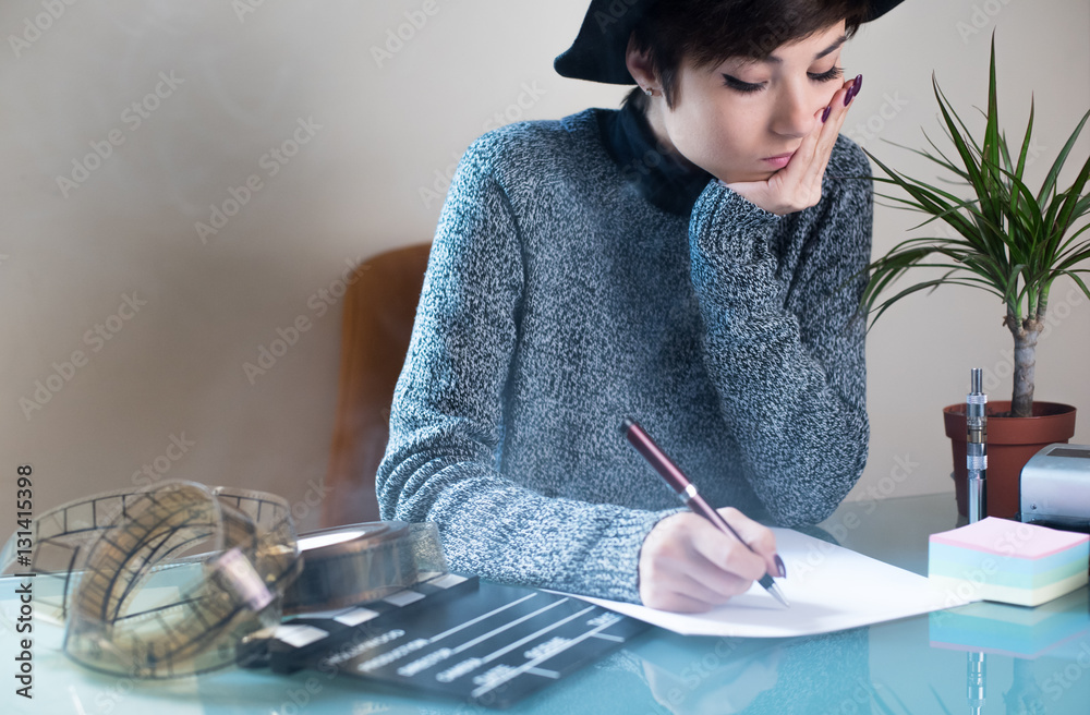 Naklejka premium Young woman screenwriter working desktop