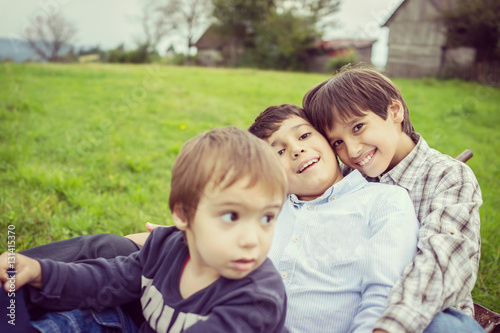 Happy kids on field playing with cart