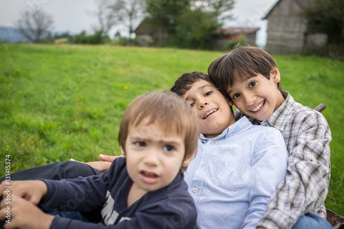 Happy kids on field playing with cart