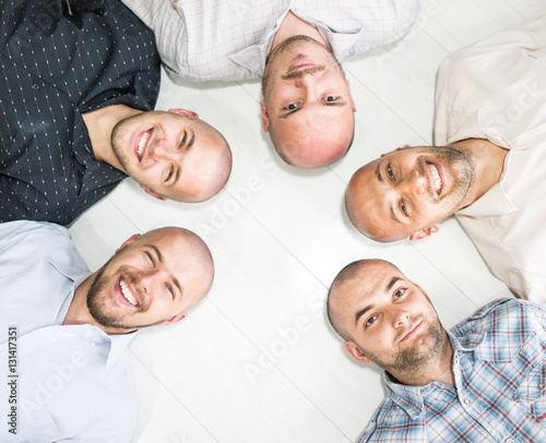 Group portrait of young bald men photo