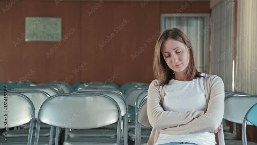 Woman falls asleep in the empty conference hall of cruise ship. Woman falls asleep in the empty conference hall of cruise ship.