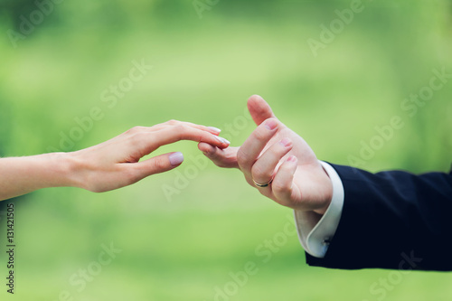 Cropped image of a newlywed couple  holding their hands © SokRom
