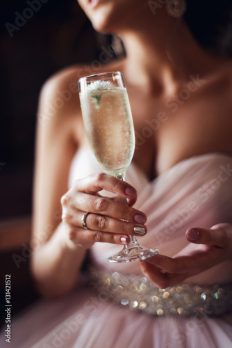 Fotótapéta Close-up portrait of a beautiful young elegant  woman with a glass of champagne