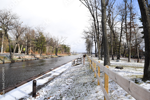 River canal across the park in cold snowy winter season