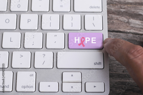 Close up of finger on keyboard button with HOPE word.