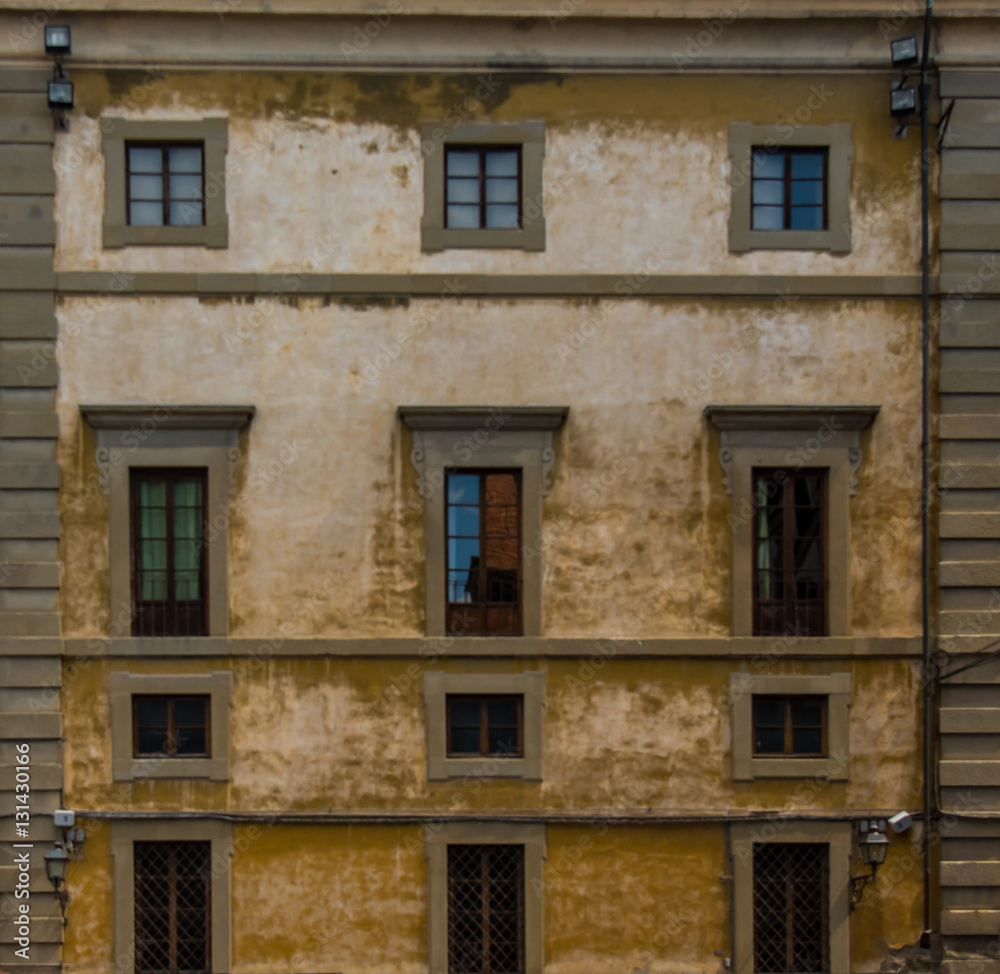 Tuscan architecture building facade with windows in Florence