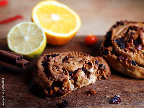 Italian food - the pitta 'mpigliata or pitta 'nchiusa, a traditional calabrian christmas sweet with cinnamon, raisins, candied fruit, honey, walnuts, almonds, hard wheat pastry.