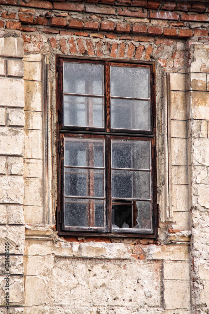 Old broken window of the cracked house