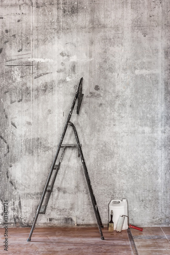 Old concrete wall in repairing room with dirty floor,tools and s