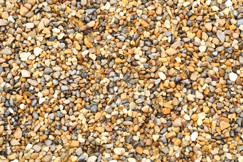 Wet small pebble as texture or background.