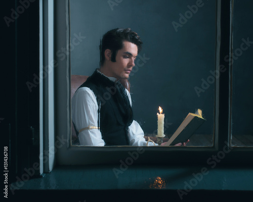 Vintage victorian man sitting by rainy window reading book with