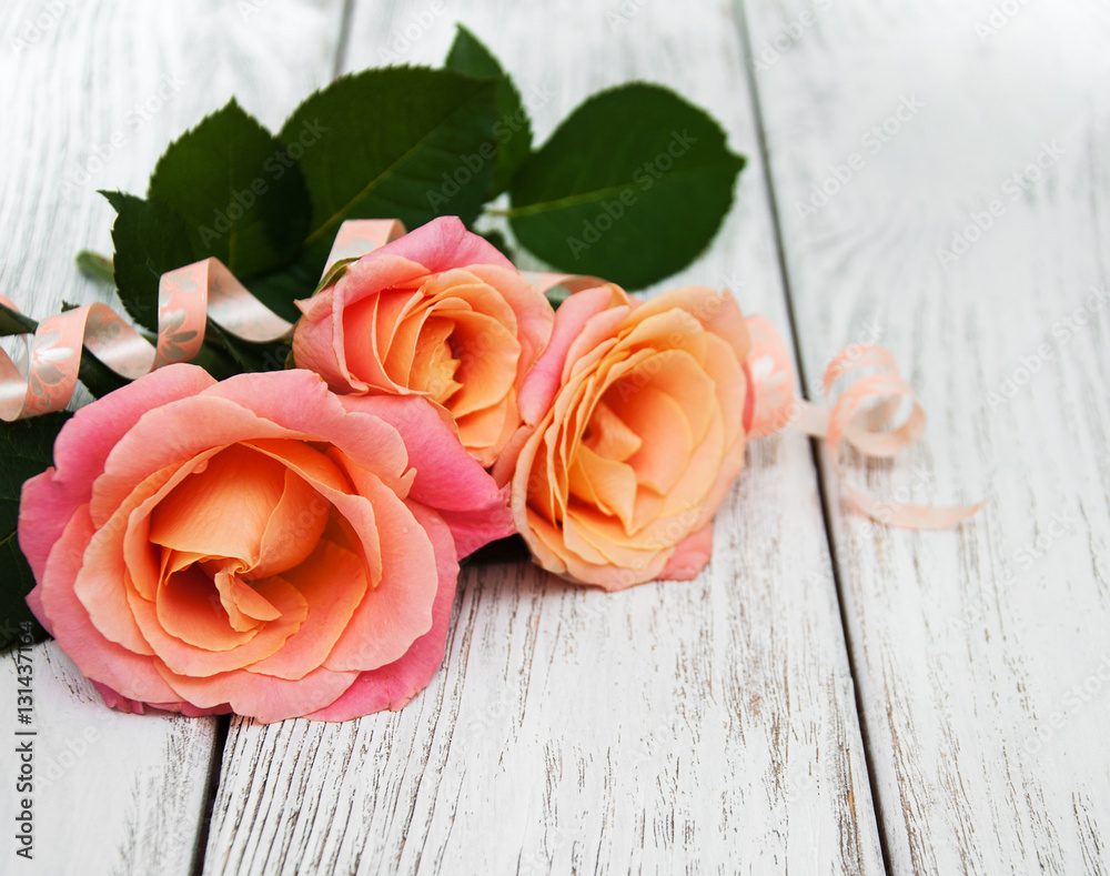 Pink roses on a wooden background Pink roses on a wooden background