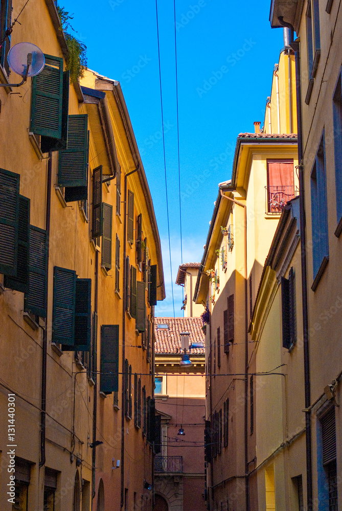 Clear blue sky peeking through onto a Bologna alley. 