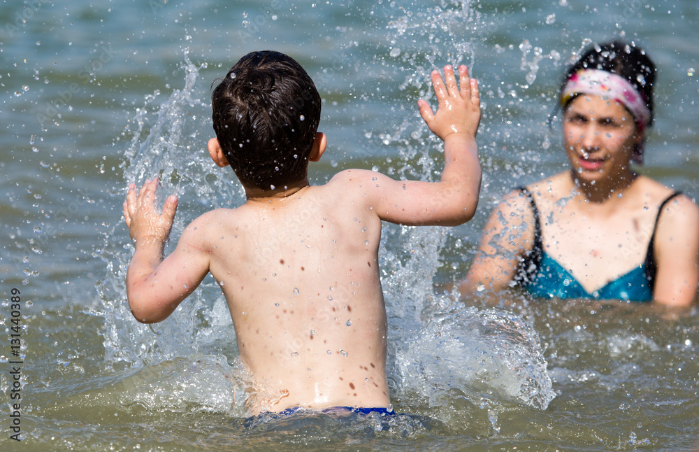 Fototapeta premium Mom and son swimming in the lake