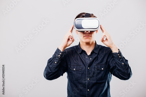 Young man with virtual reality glasses isolated on white background