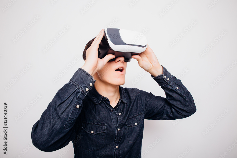 Attractive man with virtual reality glasses isolated on a white background Attractive man with virtual reality glasses isolated on a white background
