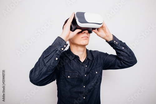 Attractive man with virtual reality glasses isolated on a white background © F8  \ Suport Ukraine