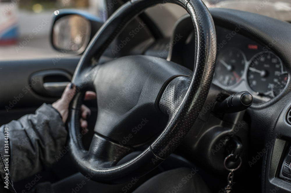 Closeup of woman hand on the steering wheel