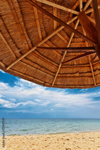 Fototapeta Naklejka Na Ścianę i Meble -  Wooden umbrella on white sand beach