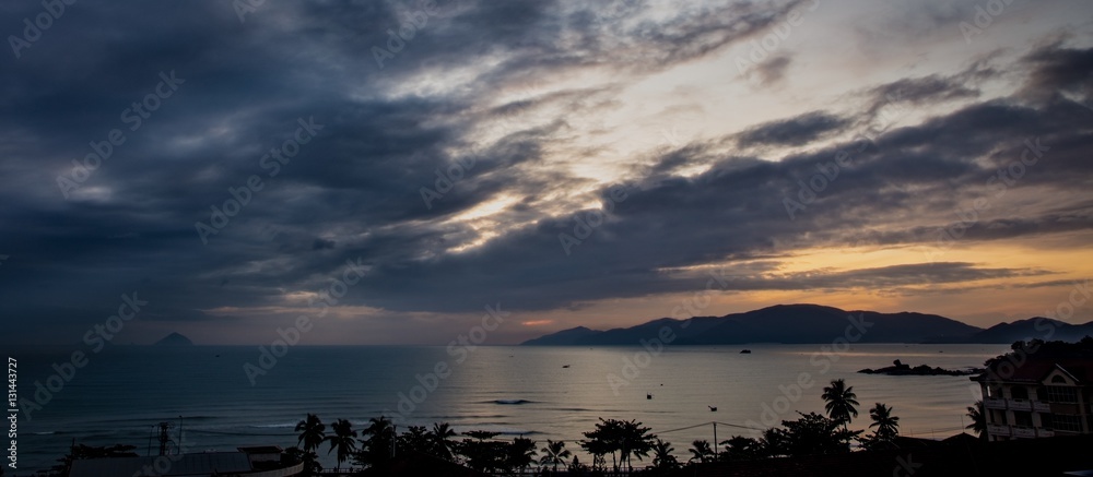 A cloudy sunrise over the south china sea and vinpearl island Vietnam.