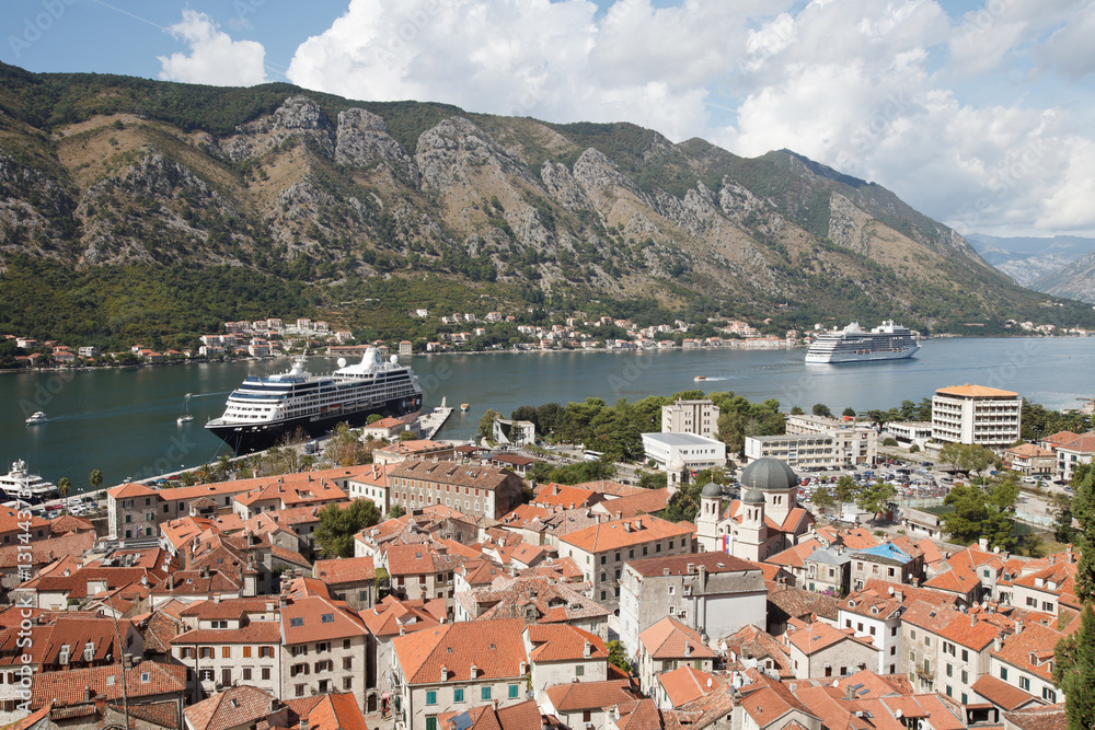 View on the old city in Kotor fortress, mountain and cruise ship in port. Montenegro