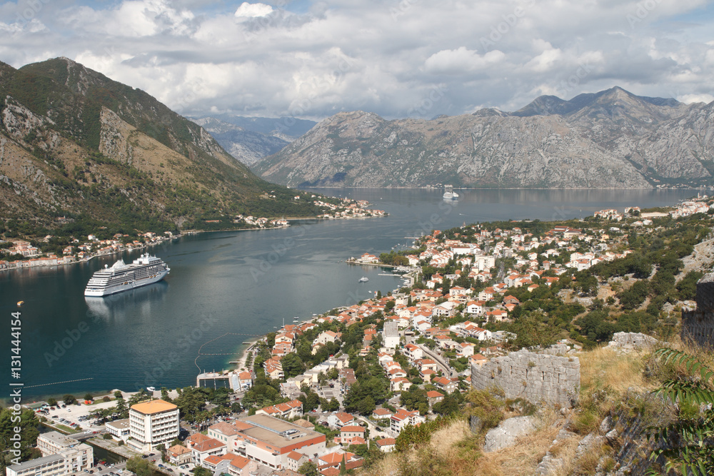 Ancient town of Kotor on the shore of the Bay of Kotor, surrounded by mountains. 