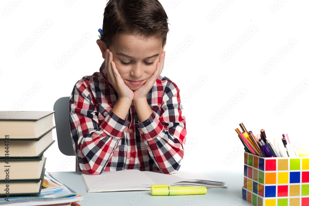 Schoolboy struggling to do math calculations. Boy doing homework Schoolboy struggling to do math calculations. Boy doing homework