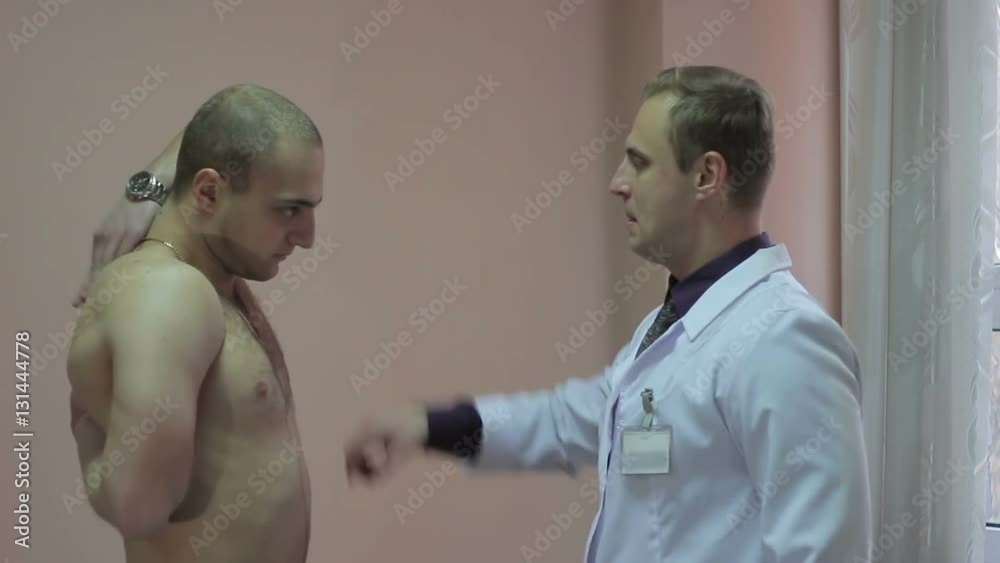Good looking sports athlete having shoulder injury examined. Good looking sports athlete having shoulder injury examined.