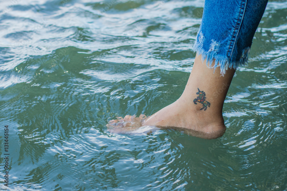 Woman relaxing and dipping feet in water