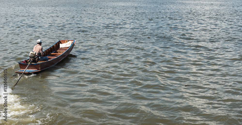 Small fast wooden boat on a river