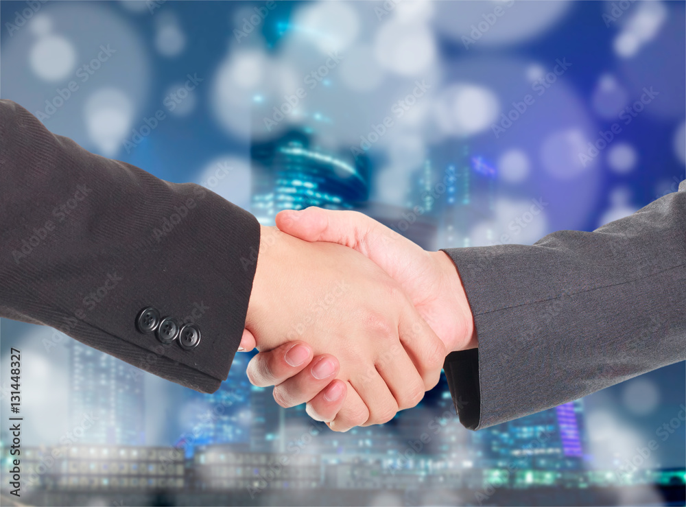 Double exposure of handshake and city Double exposure of handshake and city