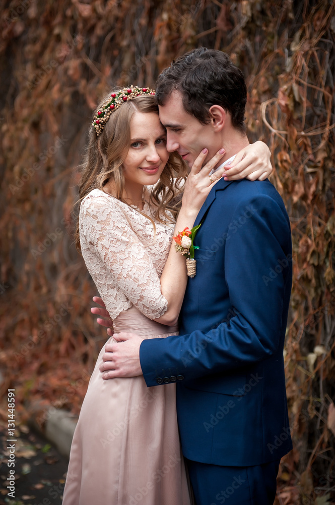 Portrait of happy newlyweds in autumn nature. Happy bride and gr Portrait of happy newlyweds in autumn nature. Happy bride and gr