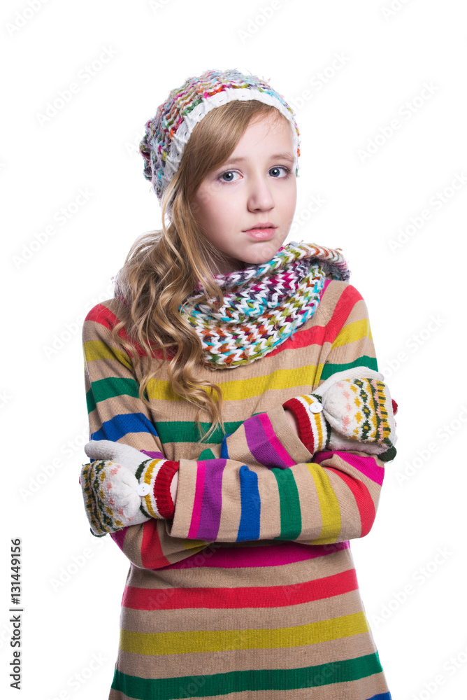 Cute cheerful teenage girl wearing colorful striped sweater, scarf, gloves and hat isolated on white background. Winter clothes. Cute cheerful teenage girl wearing colorful striped sweater, scarf, gloves and hat isolated on white background. Winter clothes.