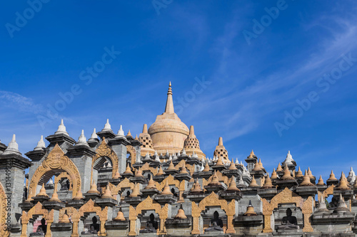 Sandstone pagoda in wat Pa Kung temple at Roi Et of Thailand on blue sky